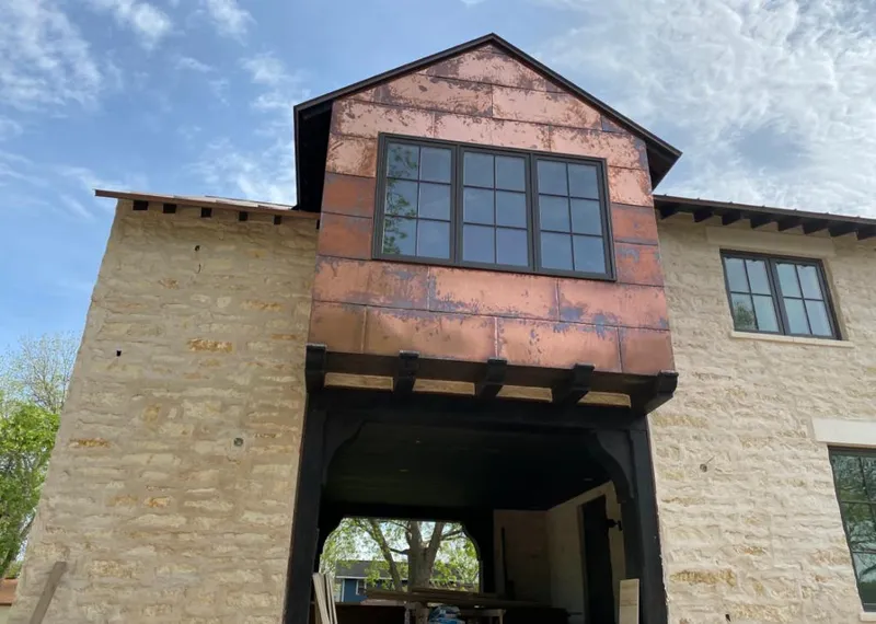 Copper metal panel facade on a stone building for Skylight Installation in Lehigh